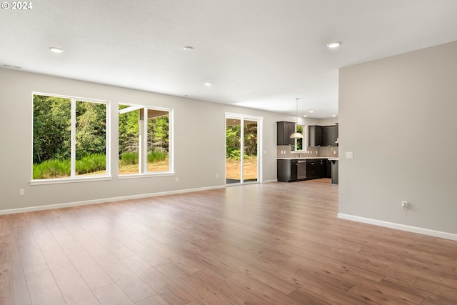 unfurnished living room with light wood-type flooring