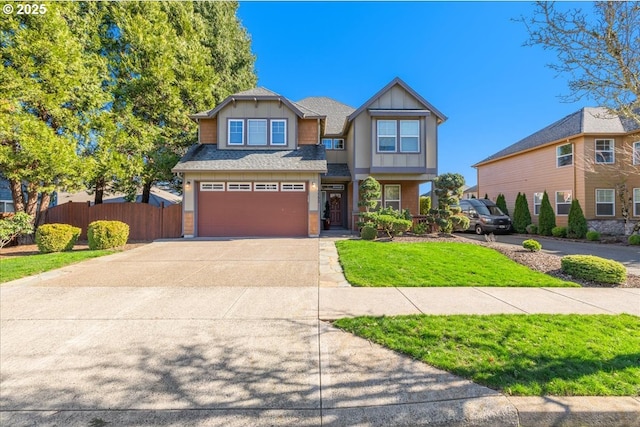 craftsman-style house with fence, board and batten siding, concrete driveway, a front yard, and an attached garage