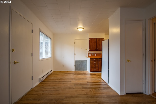 hall featuring a baseboard radiator and light wood-type flooring