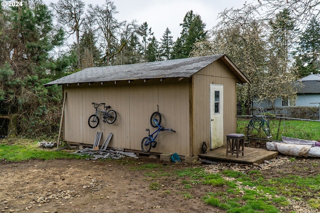 view of shed featuring fence
