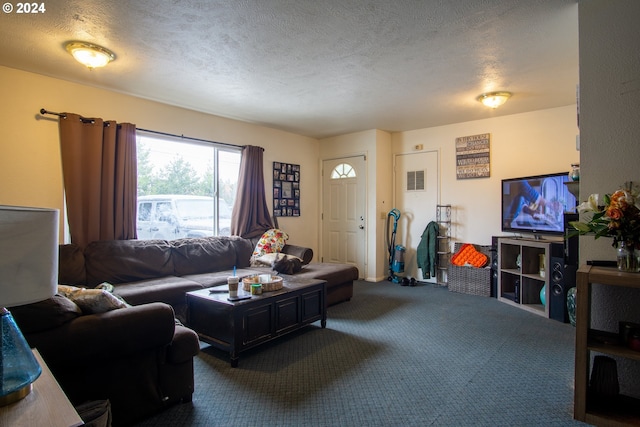 living room featuring dark carpet and a textured ceiling