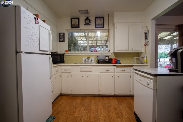 kitchen with white appliances, light hardwood / wood-style floors, and white cabinetry