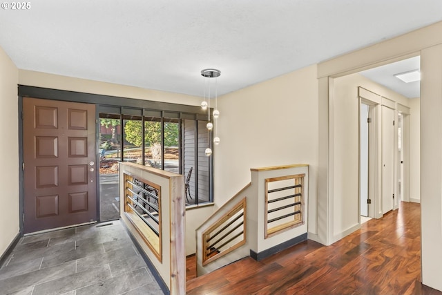 foyer with wood finished floors and baseboards