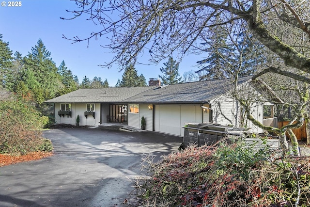 ranch-style home featuring a garage