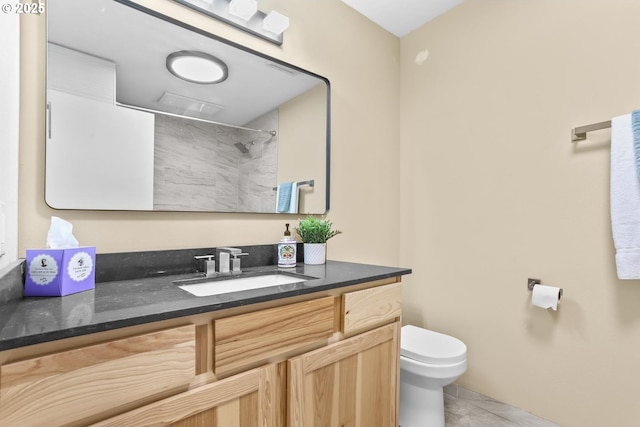 bathroom with a shower, vanity, toilet, and tile patterned floors