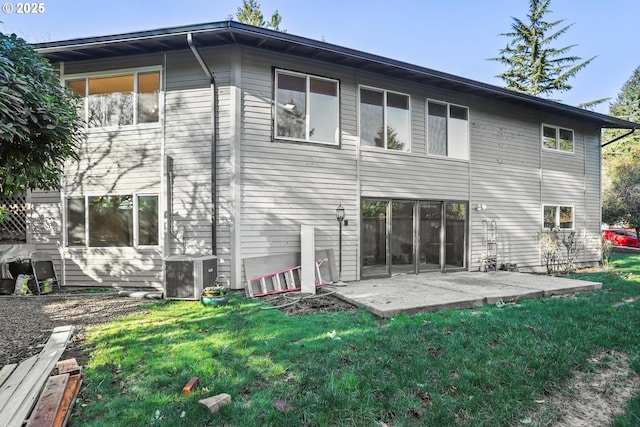 back of house with a patio, a yard, and central air condition unit