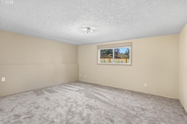 carpeted spare room featuring a textured ceiling