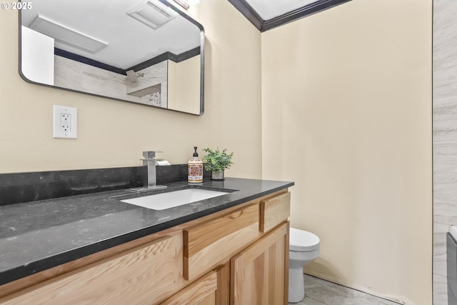 bathroom with visible vents, vanity, toilet, and crown molding