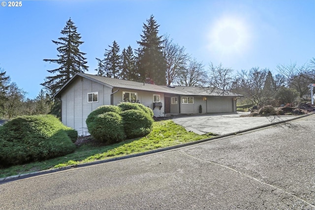 single story home with a garage and driveway