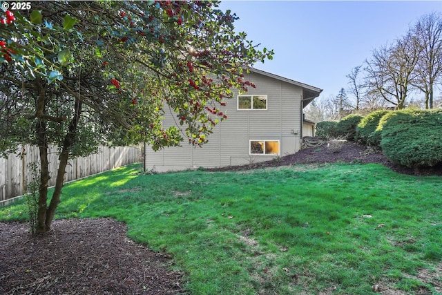 view of yard with a garage and fence