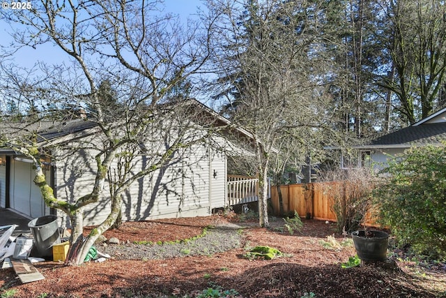 view of side of home featuring fence