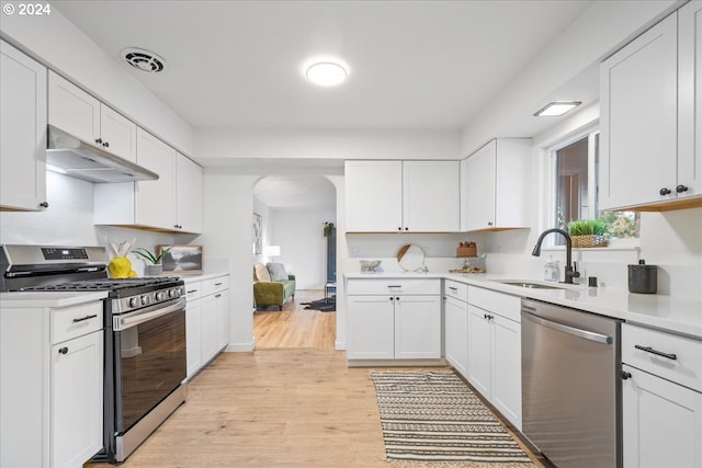 kitchen featuring white cabinetry, sink, and appliances with stainless steel finishes