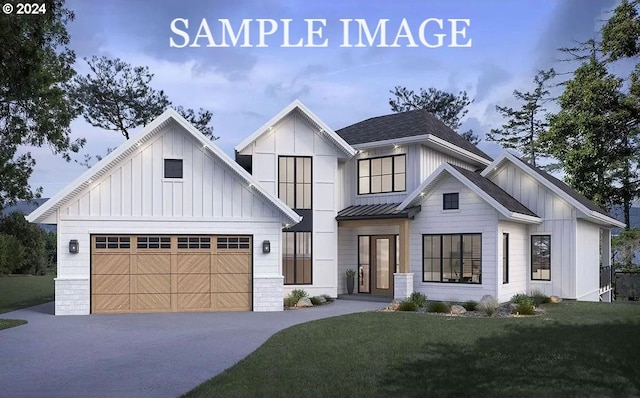 view of front of property featuring a front yard and a garage