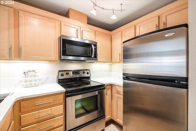 kitchen with light brown cabinetry and stainless steel appliances