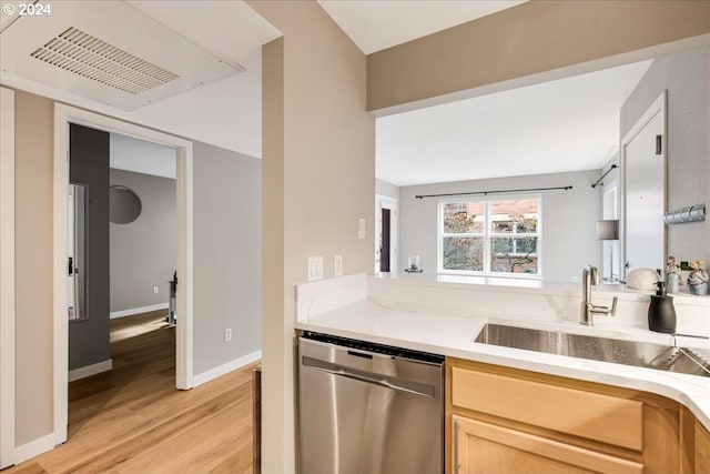 kitchen featuring stainless steel dishwasher, light brown cabinets, sink, and light hardwood / wood-style floors