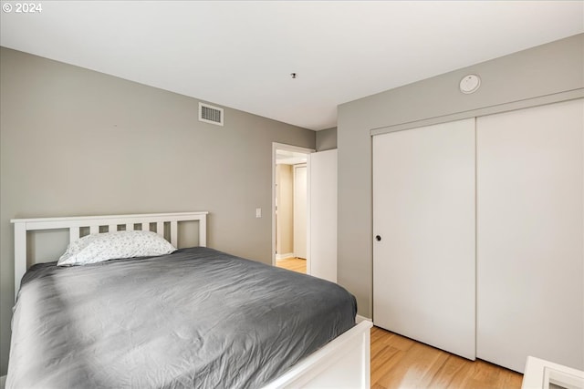 bedroom featuring light hardwood / wood-style floors and a closet