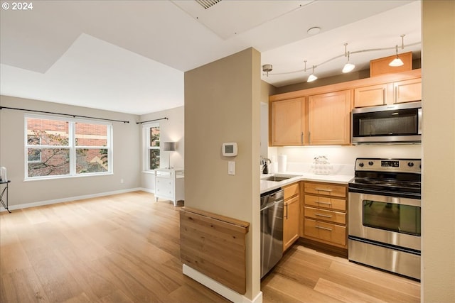 kitchen featuring light hardwood / wood-style flooring, light brown cabinets, sink, and stainless steel appliances