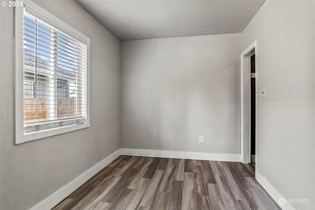 spare room with dark hardwood / wood-style floors