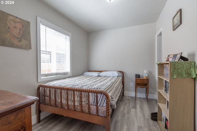 bedroom featuring multiple windows and light hardwood / wood-style floors