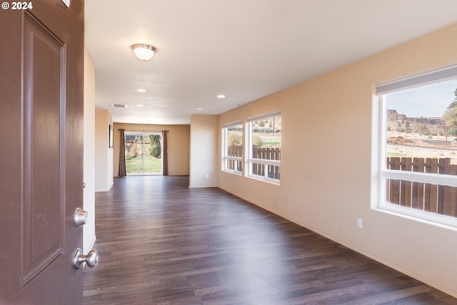 empty room with dark wood-type flooring