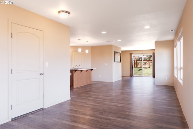 unfurnished living room with dark hardwood / wood-style flooring