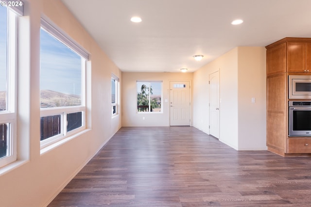 unfurnished living room with dark wood-type flooring