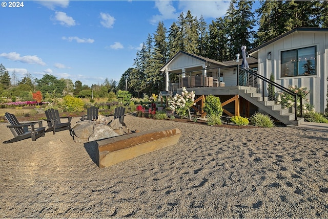 exterior space with an outdoor fire pit and a deck