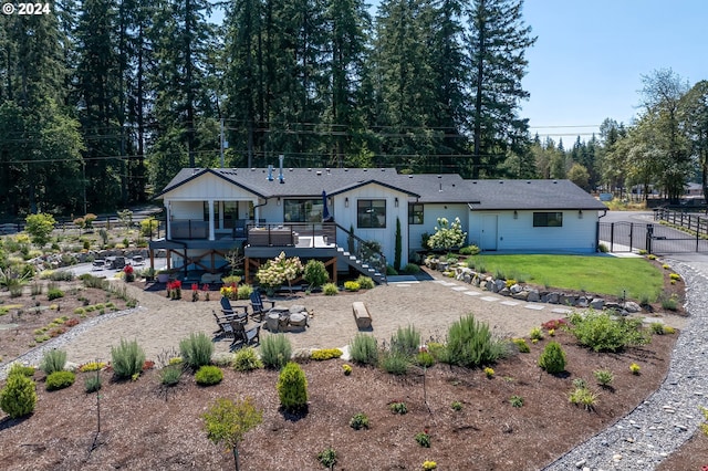 view of front of property with a wooden deck, a patio, and a front lawn