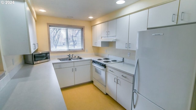 kitchen with sink, white cabinets, and white appliances