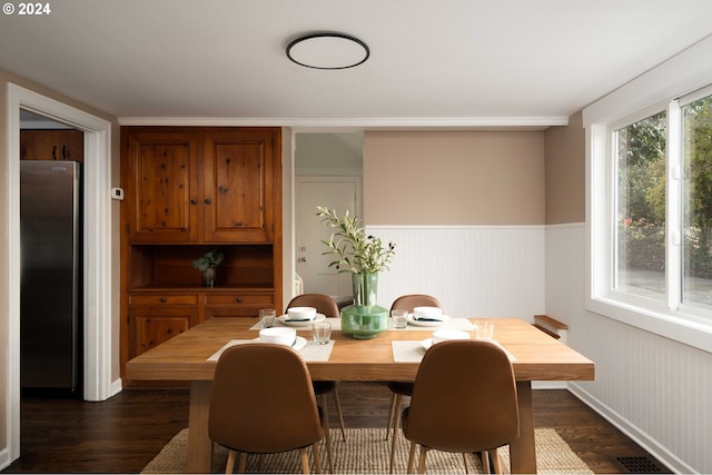 dining room with visible vents, wainscoting, and dark wood-style flooring