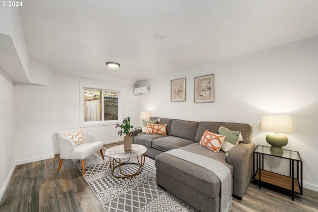 living room featuring baseboards, a wall unit AC, and wood finished floors