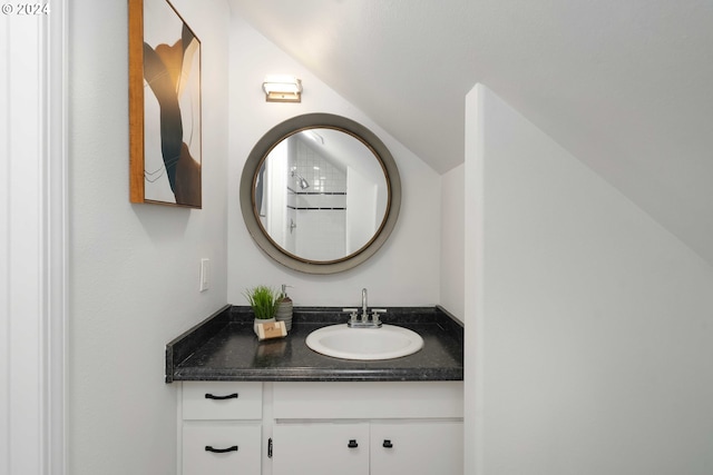 bathroom featuring vanity and lofted ceiling