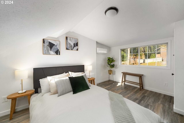 bedroom featuring lofted ceiling, wood finished floors, baseboards, and a wall mounted AC