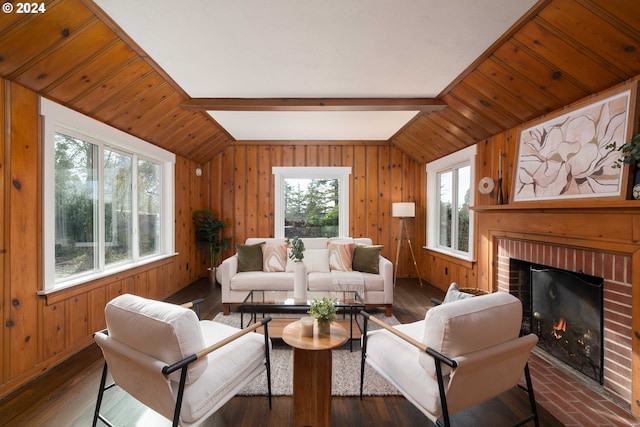 living area featuring wood walls, a fireplace, vaulted ceiling with beams, and dark wood-type flooring