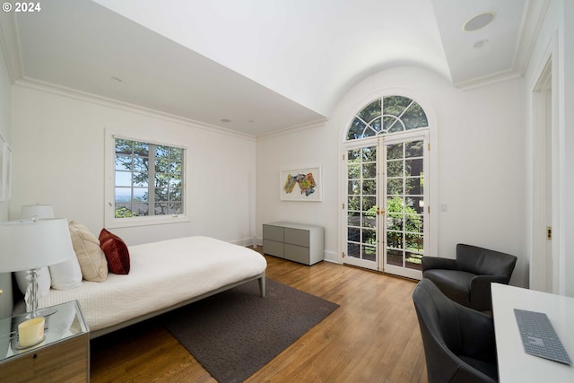 bedroom with access to outside, french doors, vaulted ceiling, ornamental molding, and light wood-type flooring