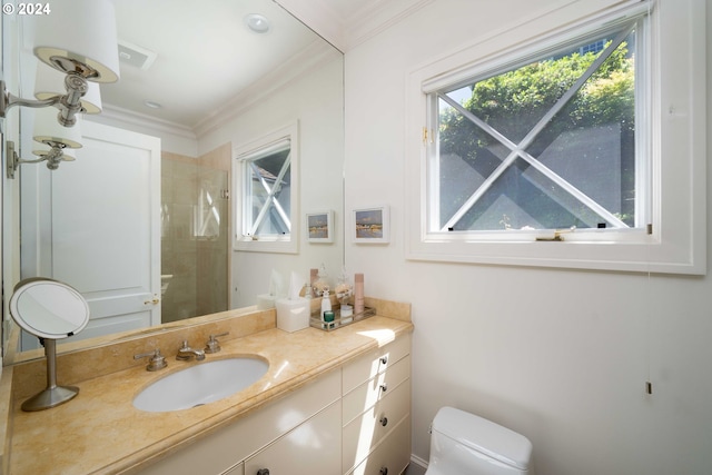 bathroom featuring vanity, toilet, a shower with shower door, and crown molding