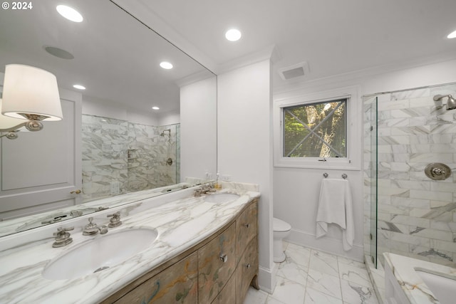 bathroom featuring toilet, a tile shower, crown molding, and vanity