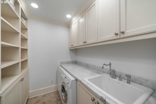 laundry area with sink, cabinets, and washer / dryer