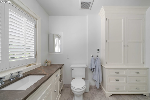 bathroom with tile patterned flooring, vanity, and toilet