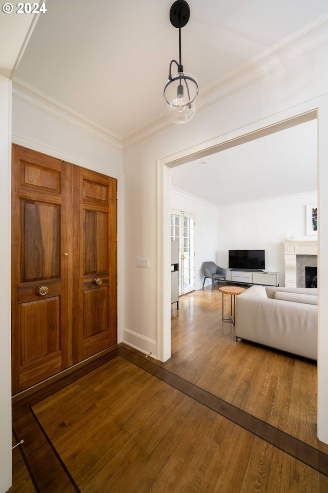 foyer featuring dark hardwood / wood-style floors and crown molding