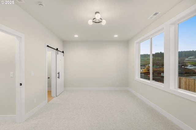 12010 SW Trask St Unit Lt94, Beaverton, OR 97007 - empty room featuring a barn door, light carpet, recessed lighting, baseboards, and a smoke detector