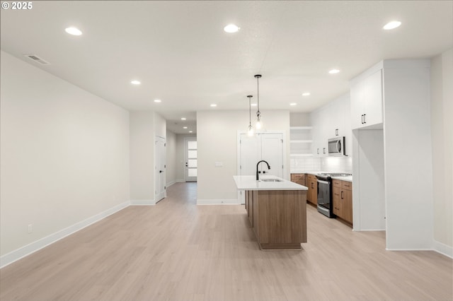 12010 SW Trask St Unit Lt94, Beaverton, OR 97007 - kitchen with stainless steel microwave, a sink, gas range oven, light wood finished floors, and baseboards
