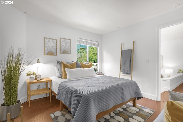 bedroom with hardwood / wood-style floors