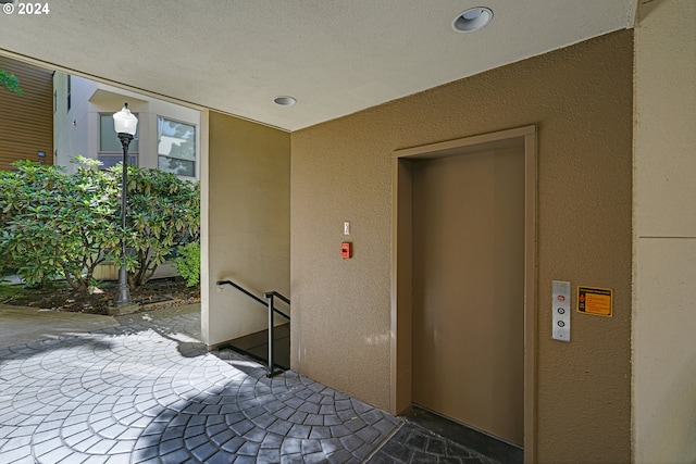 view of exterior entry with a patio