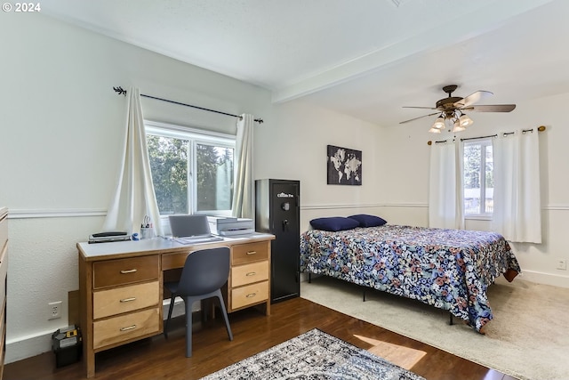 bedroom featuring ceiling fan, beam ceiling, and dark hardwood / wood-style flooring