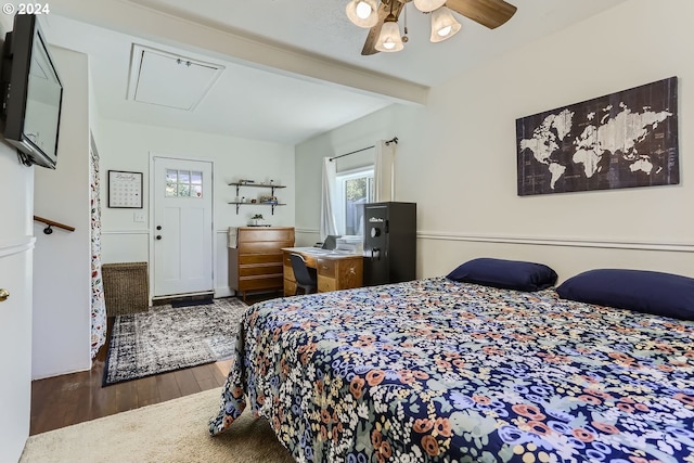 bedroom with beamed ceiling, dark hardwood / wood-style flooring, and ceiling fan