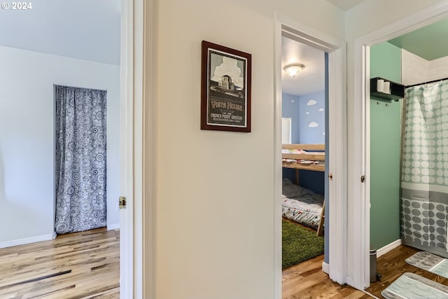 corridor with light hardwood / wood-style floors