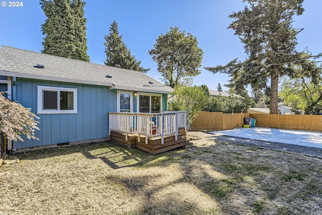 back of property featuring a patio, a deck, and a lawn