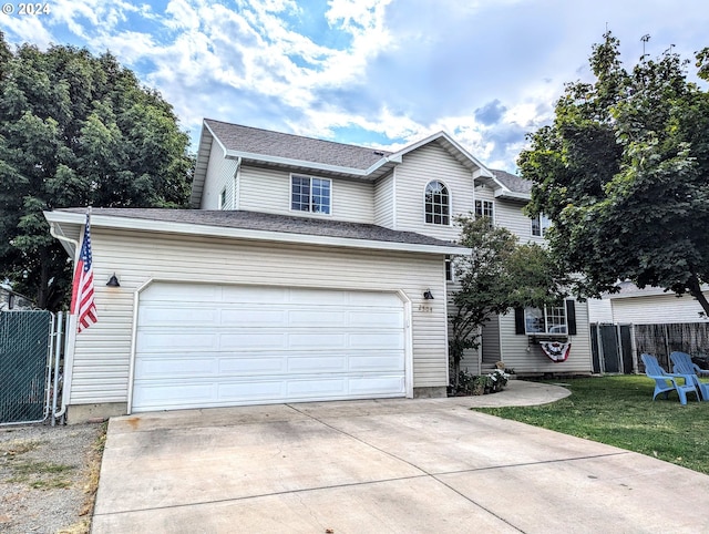 front facade with a front lawn and a garage