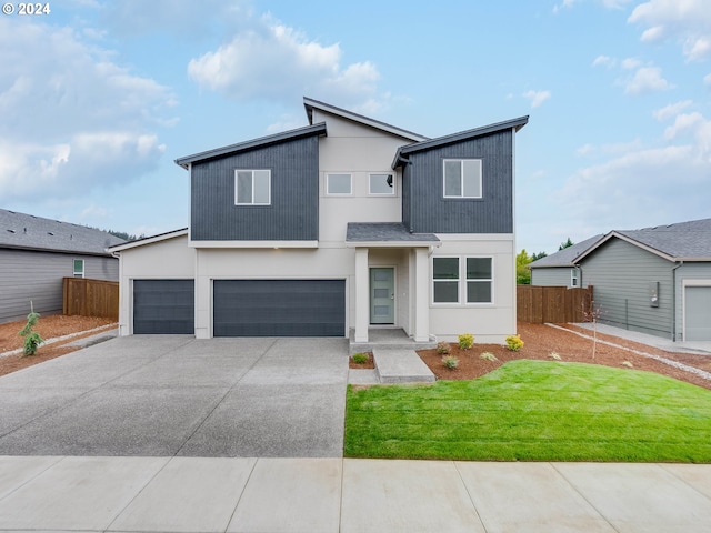 view of front of house featuring a front lawn and a garage